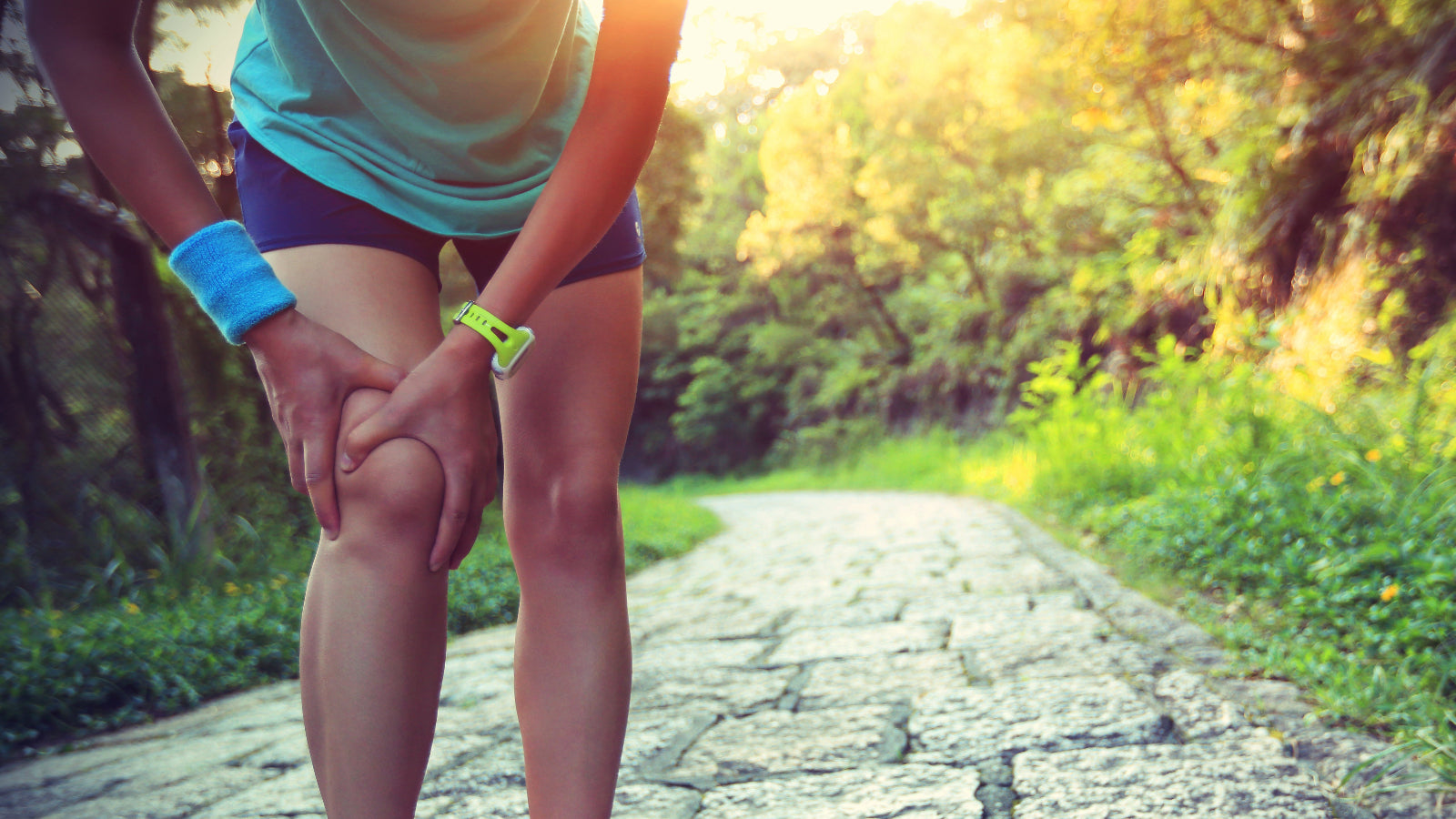 Active Female Outdoors Holding Knee